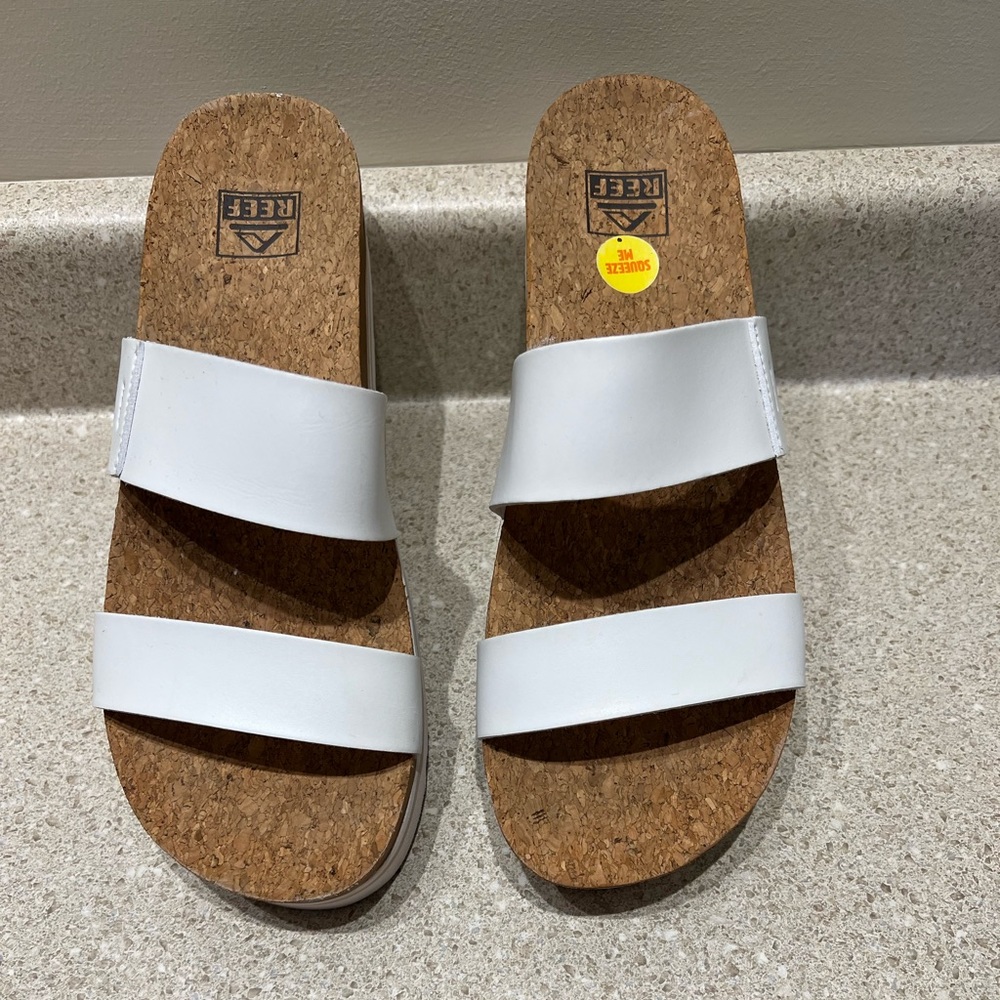 Very gently used women’s Reef platform sandals in white, size 11.